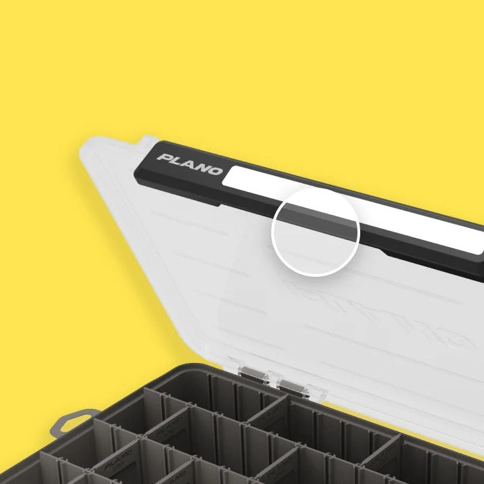Open tackle box with 'Plano' branding on a yellow background. A circle highlights the one-handed latch feature