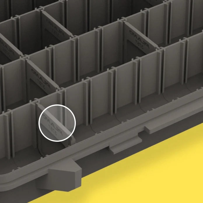 Close-up of a grey plastic dividers within the box to highlight the pre-cut dividers, on a yellow background